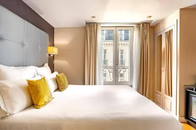 Un ou plusieurs lits dans un hébergement de l'établissement Hotel Opéra Marigny