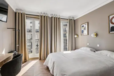 Un ou plusieurs lits dans un hébergement de l'établissement Hotel Margot