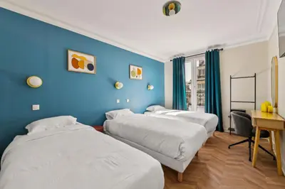 Un ou plusieurs lits dans un hébergement de l'établissement Hotel Margot