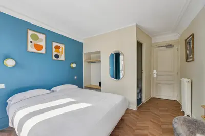 Un ou plusieurs lits dans un hébergement de l'établissement Hotel Margot