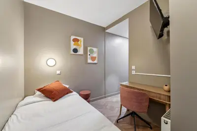 Un ou plusieurs lits dans un hébergement de l'établissement Hotel Margot