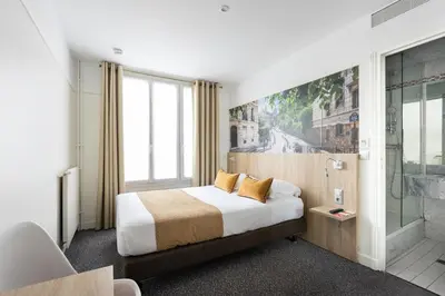 Un ou plusieurs lits dans un hébergement de l'établissement Hôtel Opera Lafayette