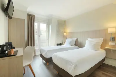 Un ou plusieurs lits dans un hébergement de l'établissement Hotel Murat