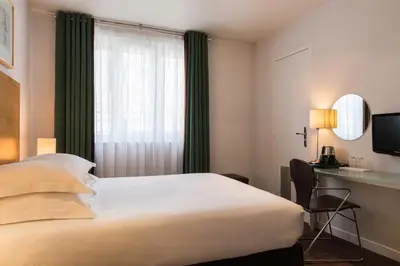Un ou plusieurs lits dans un hébergement de l'établissement Hôtel Albe Saint Michel