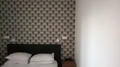 Un ou plusieurs lits dans un hébergement de l'établissement Hôtel De La Perdrix Rouge