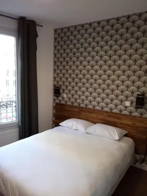 Un ou plusieurs lits dans un hébergement de l'établissement Hôtel De La Perdrix Rouge