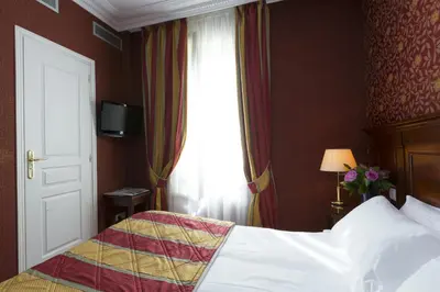Un ou plusieurs lits dans un hébergement de l'établissement Elysees Niel Hotel