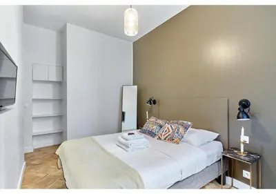 Un ou plusieurs lits dans un hébergement de l'établissement Apartment Le Marais by Studio prestige