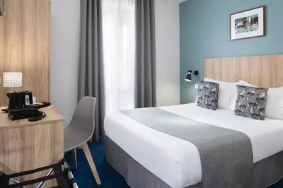 Un ou plusieurs lits dans un hébergement de l'établissement Hôtel Moulin Vert