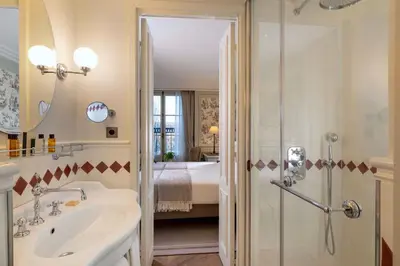 Un ou plusieurs lits dans un hébergement de l'établissement Hotel Du Quai Voltaire