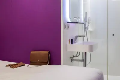 Un ou plusieurs lits dans un hébergement de l'établissement Hôtel Odyssey
