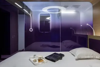 Un ou plusieurs lits dans un hébergement de l'établissement Hôtel Odyssey