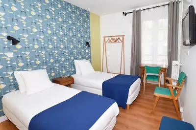 Un ou plusieurs lits dans un hébergement de l'établissement Zazie Hôtel