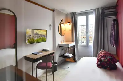 Un ou plusieurs lits dans un hébergement de l'établissement Agate Hôtel