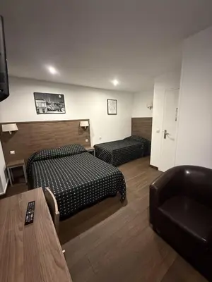 Un ou plusieurs lits dans un hébergement de l'établissement Victory Hotel Galou