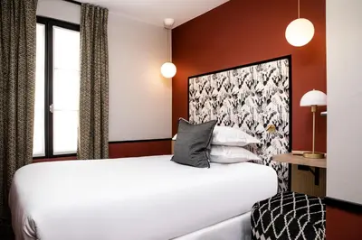 Un ou plusieurs lits dans un hébergement de l'établissement Hotel Paris Lafayette