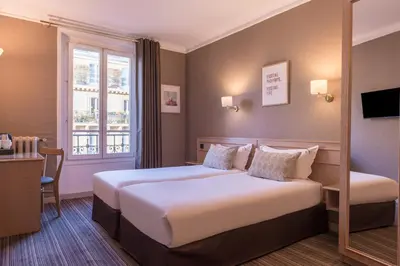 Un ou plusieurs lits dans un hébergement de l'établissement Paris France Hotel