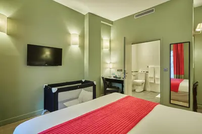 Un ou plusieurs lits dans un hébergement de l'établissement Hôtel Orchidée