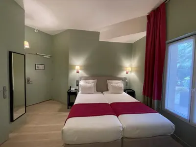 Un ou plusieurs lits dans un hébergement de l'établissement Hôtel Orchidée