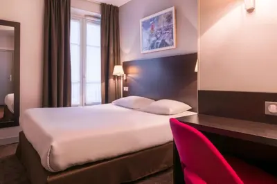 Un ou plusieurs lits dans un hébergement de l'établissement Hôtel des Ecrivains
