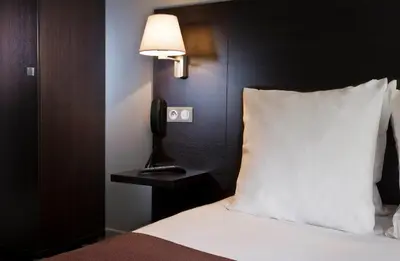 Un ou plusieurs lits dans un hébergement de l'établissement Hôtel des Ecrivains