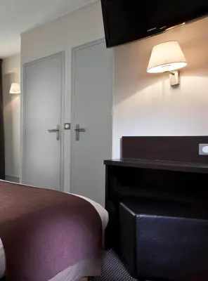 Un ou plusieurs lits dans un hébergement de l'établissement Hôtel des Ecrivains