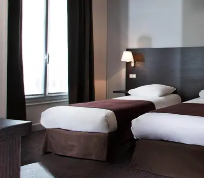 Un ou plusieurs lits dans un hébergement de l'établissement Hôtel des Ecrivains