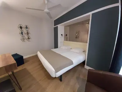 Un ou plusieurs lits dans un hébergement de l'établissement Hôtel Eiffel Kensington