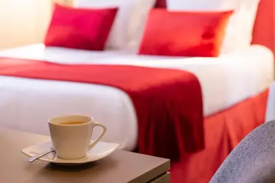 Un ou plusieurs lits dans un hébergement de l'établissement Hôtel Aston Paris