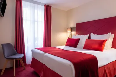 Un ou plusieurs lits dans un hébergement de l'établissement Hôtel Aston Paris