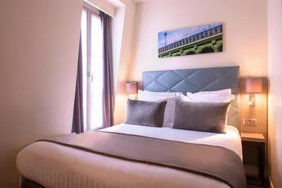 Un ou plusieurs lits dans un hébergement de l'établissement Hôtel Aston Paris