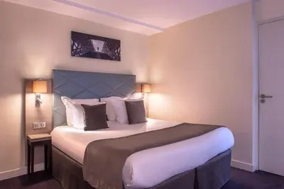 Un ou plusieurs lits dans un hébergement de l'établissement Hôtel Aston Paris