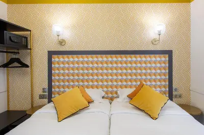 Un ou plusieurs lits dans un hébergement de l'établissement Hôtel Gérando