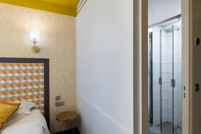 Un ou plusieurs lits dans un hébergement de l'établissement Hôtel Gérando