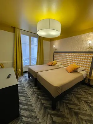 Un ou plusieurs lits dans un hébergement de l'établissement Hôtel Gérando