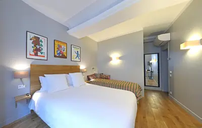 Un ou plusieurs lits dans un hébergement de l'établissement Hôtel Louvre Richelieu