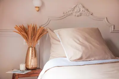 Un ou plusieurs lits dans un hébergement de l'établissement Hôtel De La Porte Dorée
