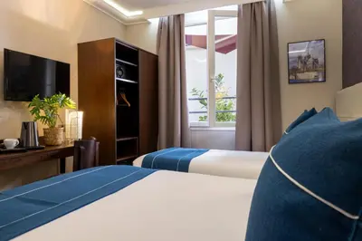Un ou plusieurs lits dans un hébergement de l'établissement Nord Est Hotel