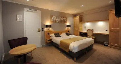 Un ou plusieurs lits dans un hébergement de l'établissement Hôtel Du Midi Paris Montparnasse