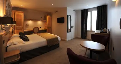 Un ou plusieurs lits dans un hébergement de l'établissement Hôtel Du Midi Paris Montparnasse