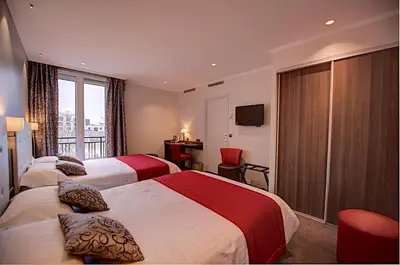Un ou plusieurs lits dans un hébergement de l'établissement Hôtel Du Midi Paris Montparnasse