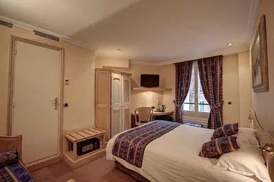 Un ou plusieurs lits dans un hébergement de l'établissement Hôtel Du Midi Paris Montparnasse