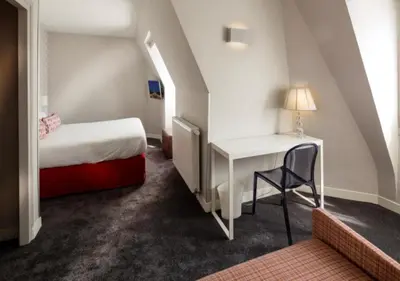 Un ou plusieurs lits dans un hébergement de l'établissement Hôtel Paris Vaugirard