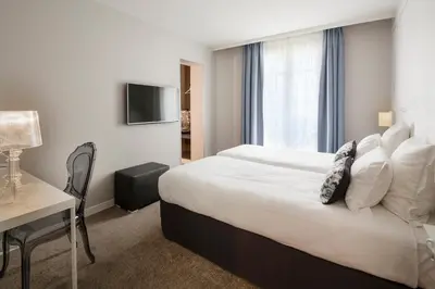 Un ou plusieurs lits dans un hébergement de l'établissement Hôtel Paris Vaugirard