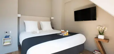 Un ou plusieurs lits dans un hébergement de l'établissement Hôtel Helzear Etoile by Esteem