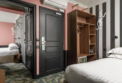 Un ou plusieurs lits dans un hébergement de l'établissement Hotel Archetype Etoile