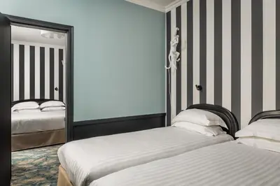 Un ou plusieurs lits dans un hébergement de l'établissement Hotel Archetype Etoile