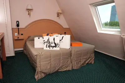 Un ou plusieurs lits dans un hébergement de l'établissement Hotel Des Arenes