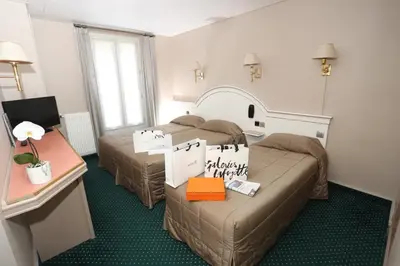 Un ou plusieurs lits dans un hébergement de l'établissement Hotel Des Arenes