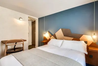 Un ou plusieurs lits dans un hébergement de l'établissement WIT Hotel